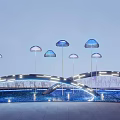 Illuminated Landscape Sculpture With Blue Umbrella Shaped Structures And Arched Bridge Over Water Pool