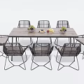 Modern Wooden Dining Table Set With Rattan Chairs And Decorative Fruit Bowls