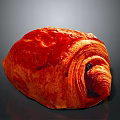 Freshly Baked Red Croissant with Shiny Golden Surface and Soft Flaky Layers