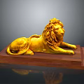 Ornate Golden Lion Statue Lying On Polished Wooden Base Decorative Art Piece