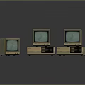 Three Vintage Computer Monitors With Green Screens On Dark Reflective Surface