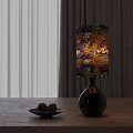 Black Base Table Lamp With Autumn Leaves Pattern Shade On Wooden Table With Pinecones