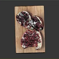 Fresh Sliced Pomegranate with Plump Red Arils on Wooden Cutting Board