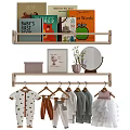 Wooden Chest of Drawers in Baby Nursery with Hanging Clothes and Decorative Paintings