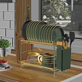 Golden Kitchenware Organizer with Green Black Plates Cups Spatulas and Transparent Kettle