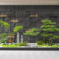 Landscape Feature Wall With Dark Stone Recessed Lighting Pine Tree Green Plants And Stone Decorations