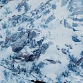 Scenic Snowy Mountain Terrain With Snow Covered Rocks And Evergreen Trees