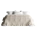 Modern Double Bed with Linen Bedspread and White Pillows in Neutral Toned Bedroom Interior
