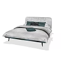 Double Bed With Gray Velvet Headboard Dark Green Pillows And Light Gray Bedding