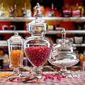 Ceramic Storage Jars With Glass Lids Holding Colorful Candy On Shop Shelves