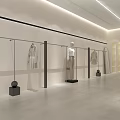 Modern Clothing Store Interior With Clothing Racks Wooden Table And Black Chairs