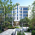 Modern Residential Building With Landscaped Gardens Trees And Contemporary Sculpture