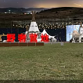 Beautiful Garden Landscape With Green Grassland White Tents Lighting Decorations And Distant Hills