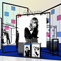 Modern Exhibition Booth Design With Display Counters Posters And Staff Members 3d model