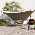 Outdoor Table And Chair Set With Canopy Grill And Green Plants On Stone Patio