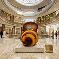 Giant Spiral Art Installation In Shopping Mall Atrium With Marble Base And Luxury Stores