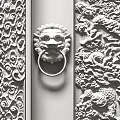 Brown And Silver Carved Double Doors With Intricate Patterns And Decorative Handles