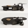 Modern Circular Black Textured Coffee Table With Books Decorative Bowl And Sculptural Base