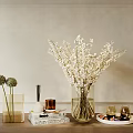 Clear Glass Vase With White Blossom Branches On Wooden Table With Books Candles And Decor
