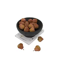Decorative Ornament Set With Black Bowl Filled With Pears On White Book And Scattered Pears