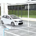 White Car Displayed On Circular Platform In Modern Glass Walled Showroom With Green Lawn