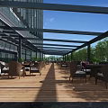 Outdoor Café Wooden Deck With Wicker Tables Chairs Metal Canopy Building And Green Trees
