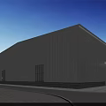 White Industrial Warehouse With Corrugated Metal Exterior Stone Base Windows Green Trees And Blue Sky