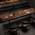 Modern Dining Area With Long Wooden Table Black Chairs Booth Seating And Potted Plant
