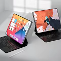 Tablet Laptops with Keyboard and Stylus Pen Displaying Colorful App Screens and Art Design