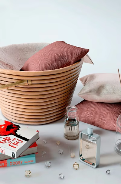 Woven Storage Basket with Pink Beige Pillows beside Books Scented Sticks Fragrance Bottles Small Decor 3d model