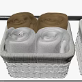 Four Brown and Gray Rolled Towels in Woven Basket Neatly Arranged