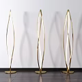 Golden Curved Modern Floor Lamps Illuminated With Shadow On Wooden Floor White Wall