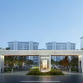 Modern Residential Entrance With Covered Gate Tall Buildings And Green Landscaping