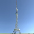 Tall Modern TV Tower With Steel Lattice Structure Standing Against Clear Blue Sky