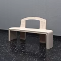 Modern Light Colored Bench With Curved Backrest On Dark Floor And Gray Wall 3d model
