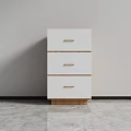 White Three Drawer Cabinet With Wooden Handles And Base Against Gray Wall And Floor