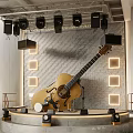 Garden Ornament Display With Acoustic Guitar Stone Wall And Square Lights