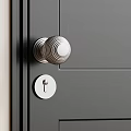 Modern Silver Metal Door Knob On Black Door With Keyhole Detail