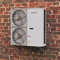 Air Conditioner Fan Outdoor Unit Mounted on Red Brick Wall Exterior