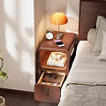 Bedside Table With Orange Lamp Alarm Clock Mobile Phone Books Cups And Drawer In Bedroom