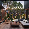 Cozy Courtyard Garden With Wooden Deck Sofa Coffee Table Fireplace Lush Green Plants And Lanterns