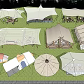 Different Types of Camping Tents in Outdoor Campsite With Grass and Trees