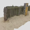 Wooden Fence Made Of Poles And Wire On Sandy Ground