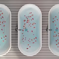 Colorful Oval Bathtubs with Red Rose Petals Floating in Water on Striped Bathroom Floor