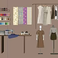 Clothes on Rack with Mannequins Sewing Machine Fabrics and Thread Spools Table