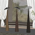 Modern Floor Lamps With Conical Bases In Three Colors By Window Blinds And Green Plants