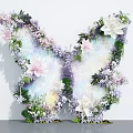 Butterfly Shaped Art Installation With Pink White Purple Flowers Green Leaves and Transparent Wings