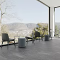 Scenic Cafe Outdoor Terrace With Black Chairs Gray Round Stools And Mountain Town View