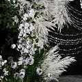 Elegant Floral Arch Decoration With White Purple Flowers And Feather Ornaments