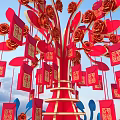 Vibrant Red Tree Decoration With Roses Envelopes And Gold Patterns Against Blue Sky